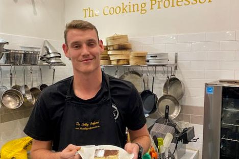 a man standing in a kitchen preparing food