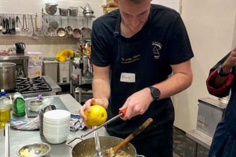 a man cooking in a kitchen preparing food