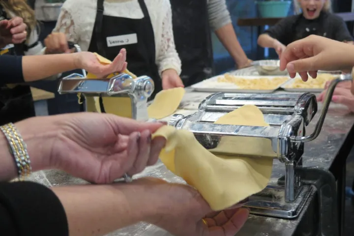 a group of people sitting on a cutting board