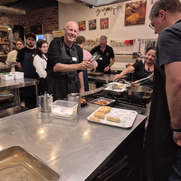 a group of people preparing food in a kitchen