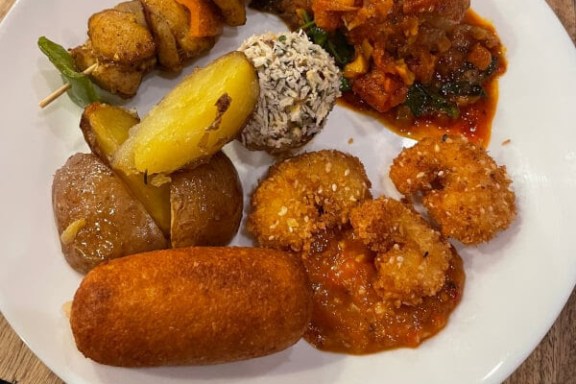 a plate of food with meat and vegetables