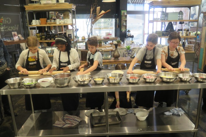 a group of people performing on a counter in a store