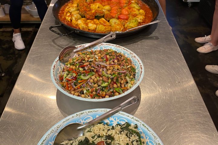 a group of people sitting at a table with a plate of food