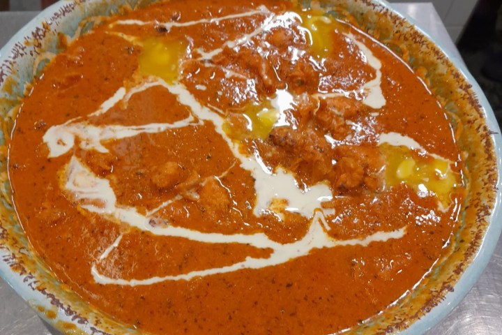 a close up of a bowl of oranges on a table