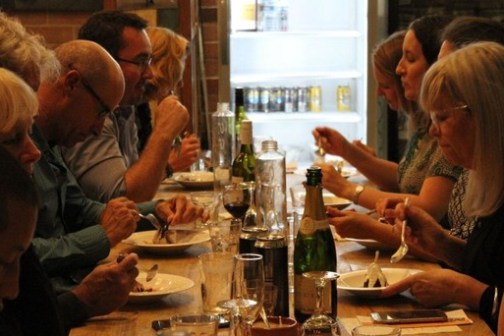 a group of people sitting at a table with wine glasses