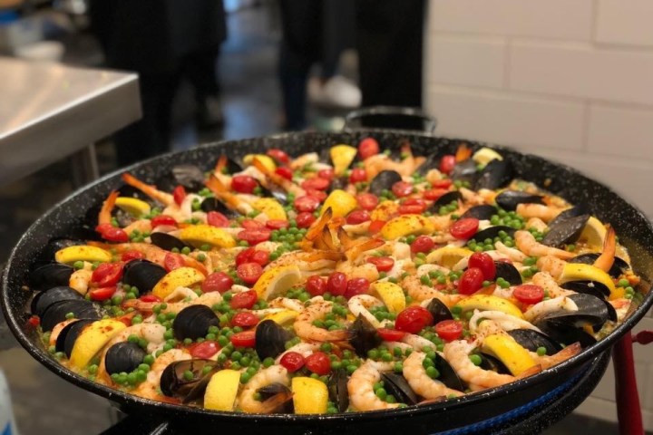 a pizza sitting on top of a pan on a stove