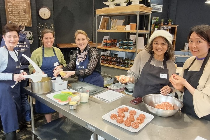 a group of people sitting at a table with food