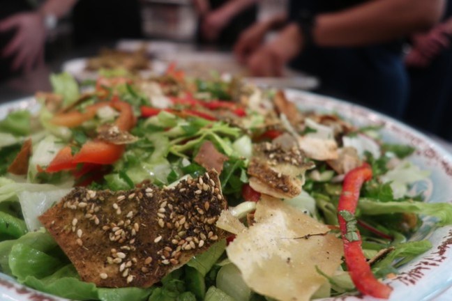 a plate of food with a slice of pizza