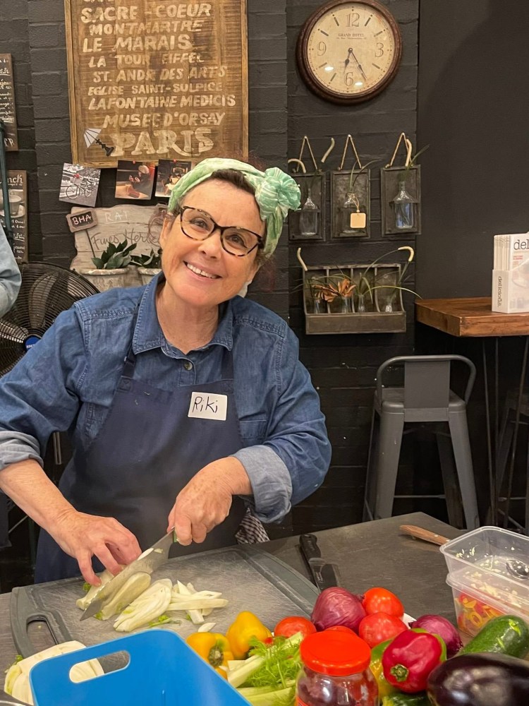 a person sitting at a table with food