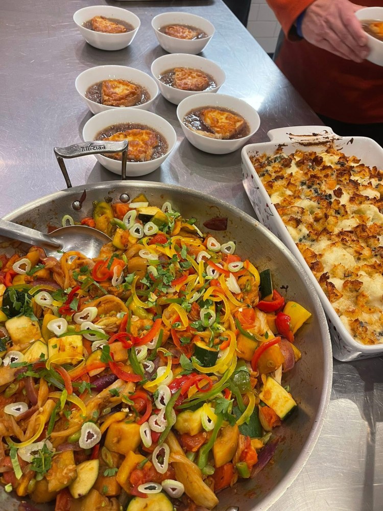 a pizza sitting on top of a table filled with food