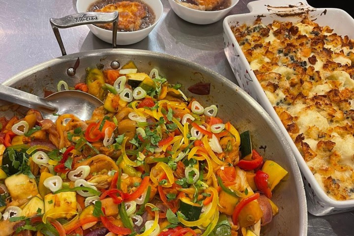 a pizza sitting on top of a table filled with food