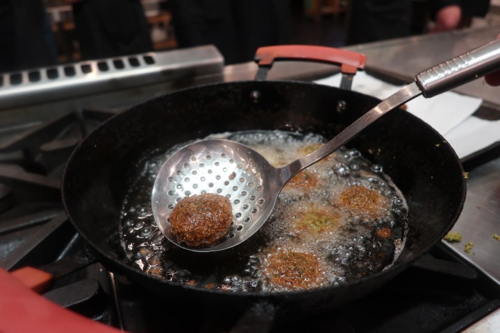 a bowl of food on a metal pan on a stove