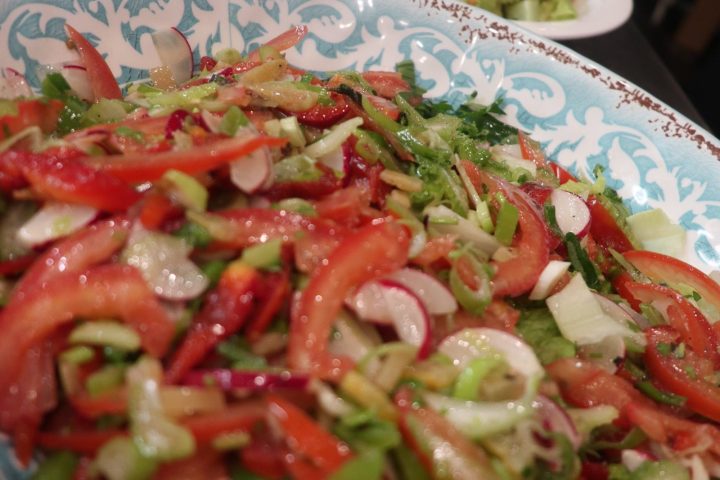 a plate of food with a slice of pizza