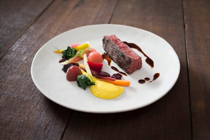 a plate of food sitting on top of a wooden table