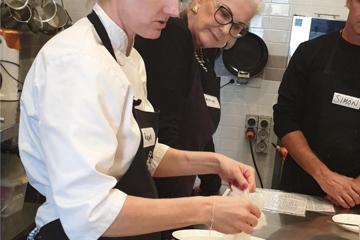a group of people standing around a table