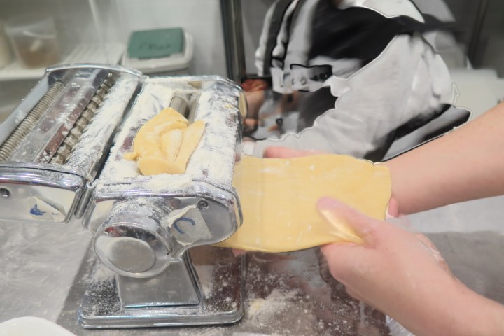 a hand holding a tray of food