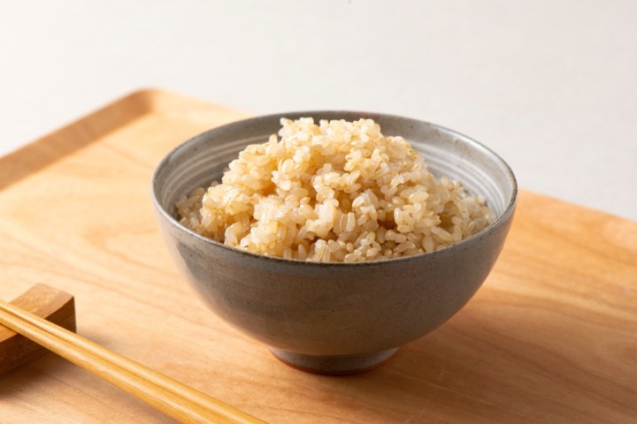 a bowl of food sitting on top of a wooden table