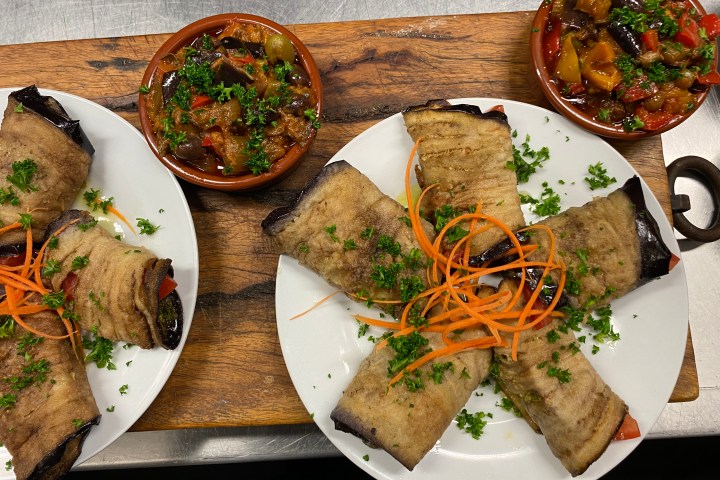 a plate topped with different types of food on a table