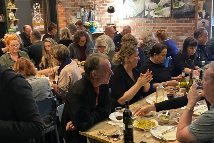 a group of people sitting at a table in a restaurant