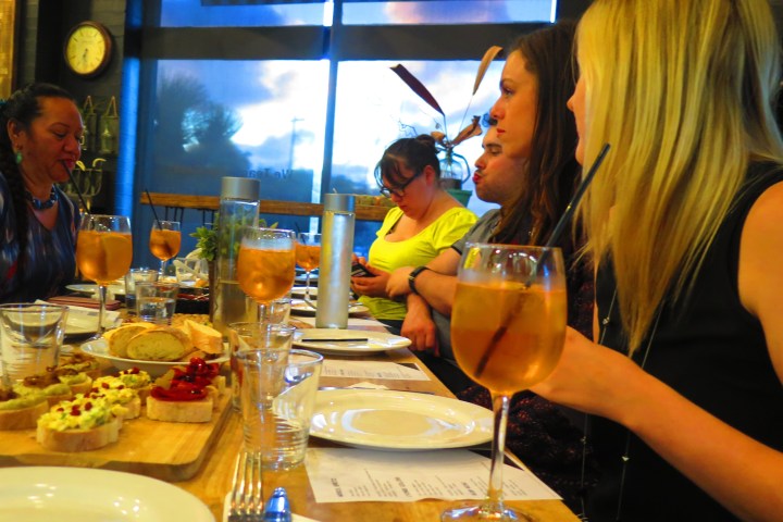 a group of people sitting at a table in a restaurant