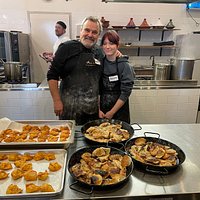 a group of people preparing food in a kitchen