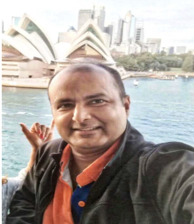 a man holding a fish in the water