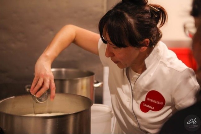 a person preparing food in a pan on a stove