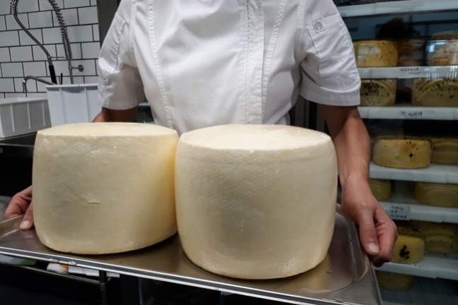 a person sitting at a table in front of a tray of food