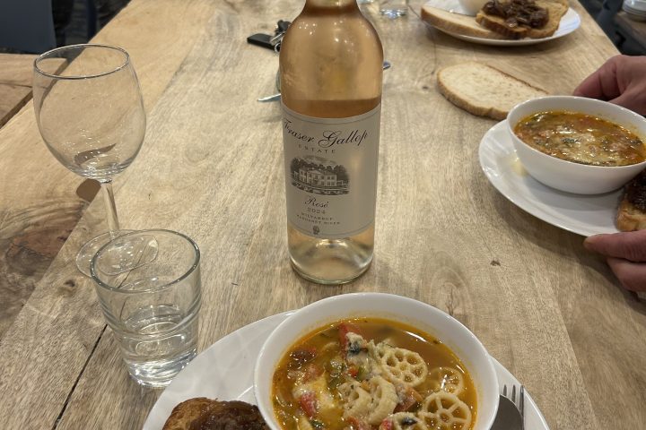 a plate of food and glasses of beer on a table