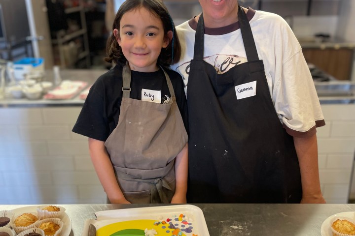 Two people in aprons at a kitchen counter with baking items.