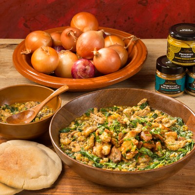 a bowl of food sitting on top of a wooden table