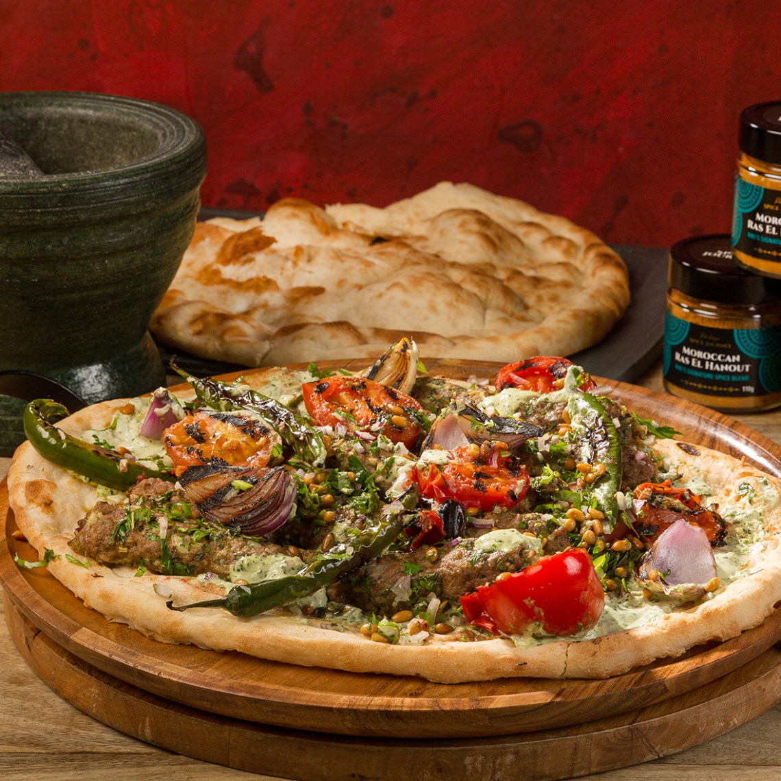 a pizza sitting on top of a wooden cutting board