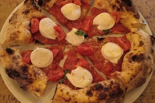 a pizza sitting on top of a plate of food